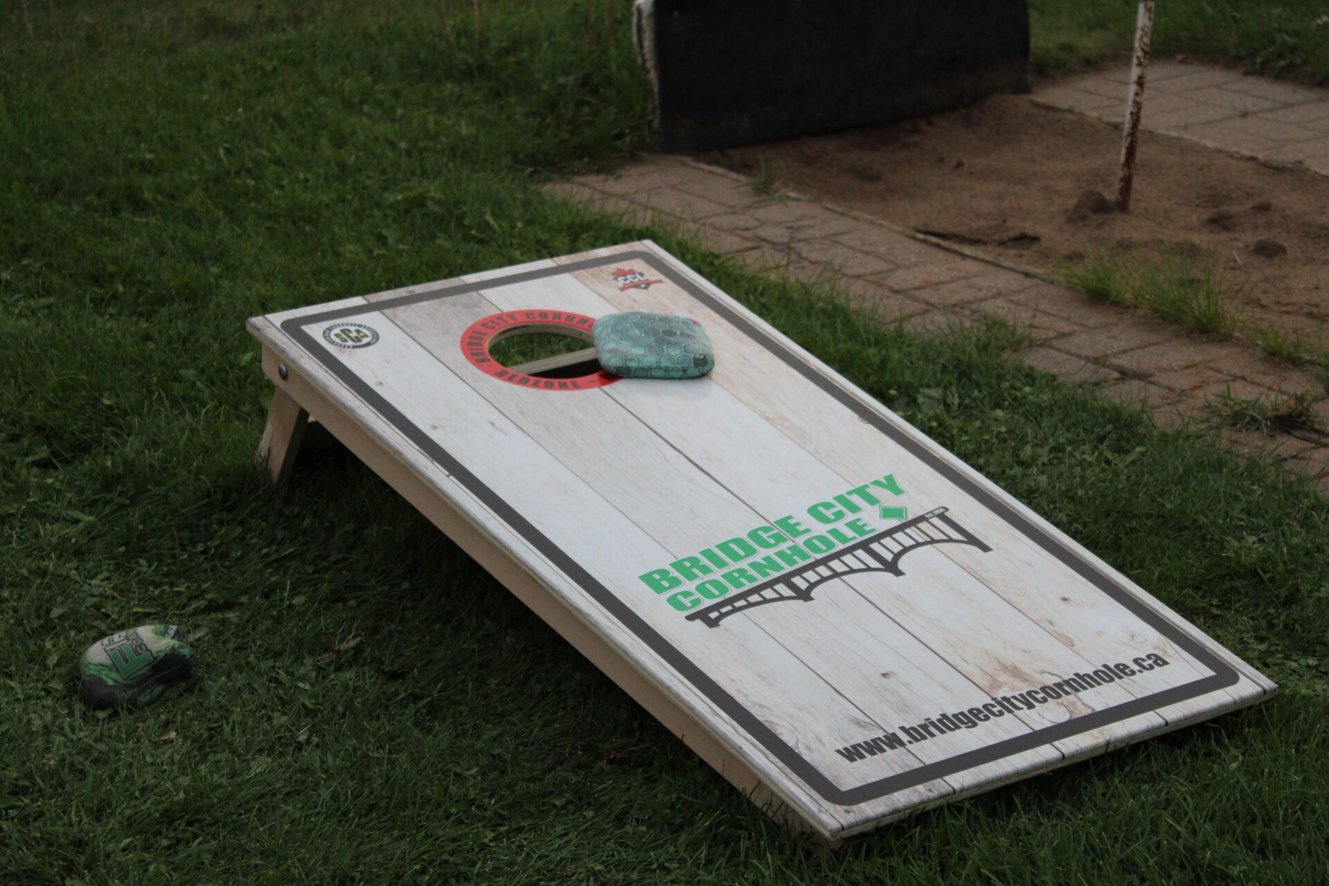 boards playing cornhole in backyard